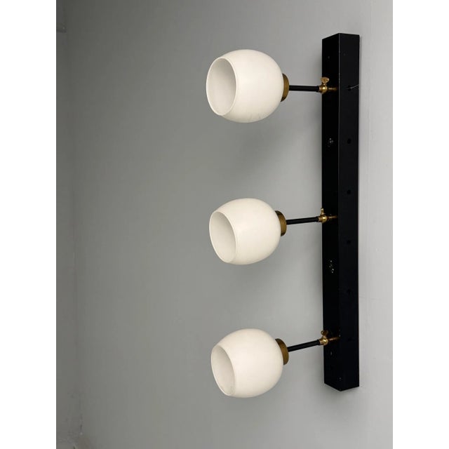 Italian Mid-Century Modern, Three Light Wall Sconce, Painted Metal, Glass, 1950s This striking single wall sconce,...