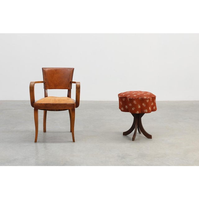 A charming French Art Deco stool from the 1920s, distinguished by its sculptural curved legs in dark stained wood and its...