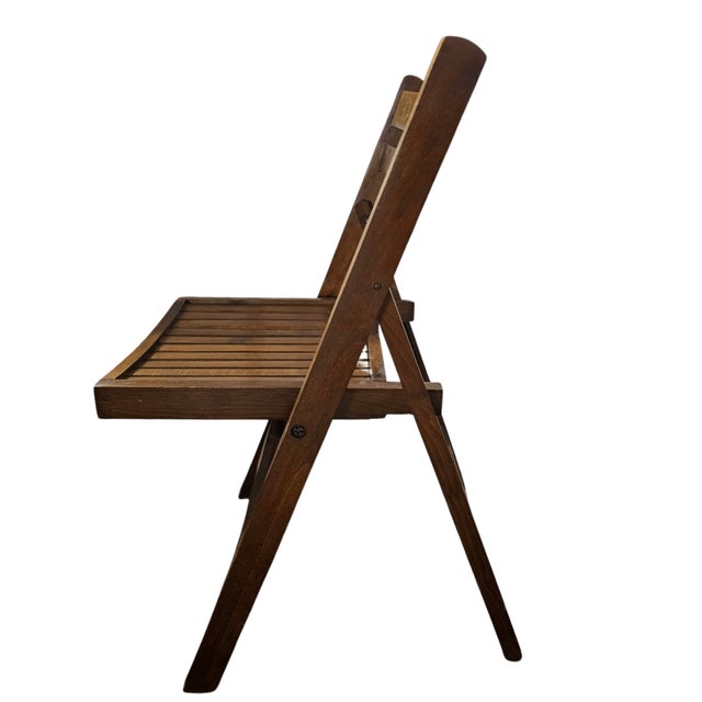 A beautifully crafted pair of mid-20th century Romanian folding chairs, featuring a timeless ladder-back silhouette and...