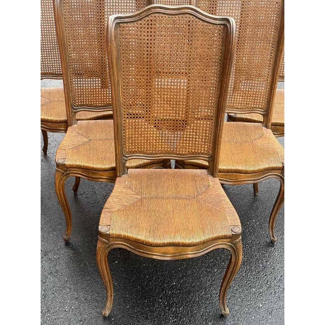 Stunning set of French Provincial-style dining chairs circa 1950s . These chairs are crafted from solid hardwood with a...