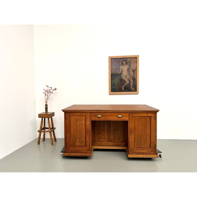 Maison Lecan presents this large antique shop counter from the early 20th century, remarkable for its double-sided design....