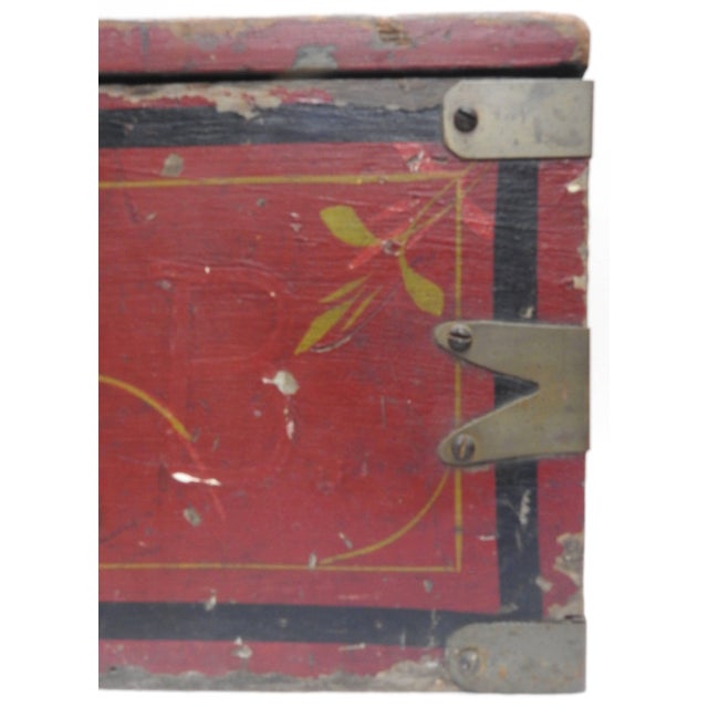Primitive red speaks volumes on this antique wooden tool box with accents of metal. The hand painted flowers and black...