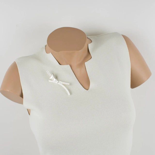 This stunning modernist pin brooch was designed by Claude Montana. It features a silverplate metal zipper design with a...