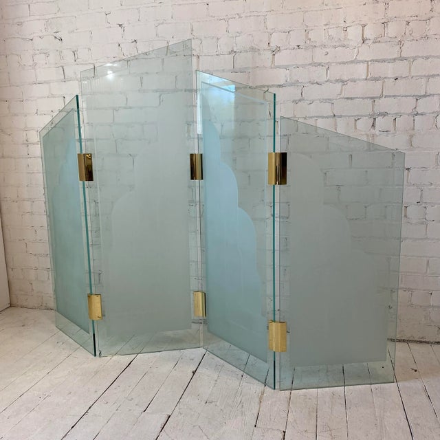 This is an amazing piece. The four glass sections are each curved and sandblasted with design. They are connected by brass...