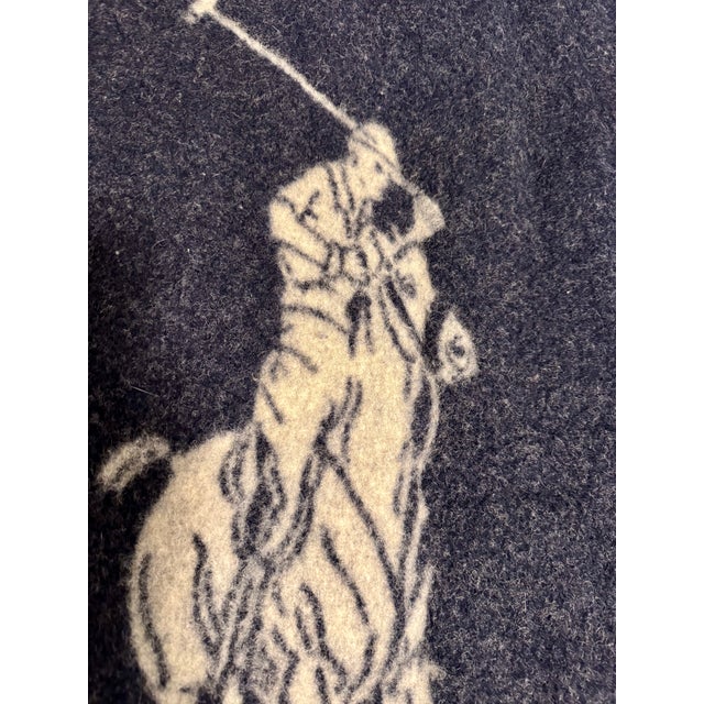 A beautifully crafted Ralph Lauren wool blanket featuring the iconic Polo equestrian motif centered within a classic...