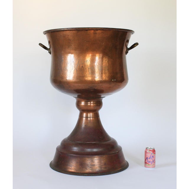 Vintage monumental footed copper planter or jardiniere with brass handles and flared base. No makers mark. Some age wear...