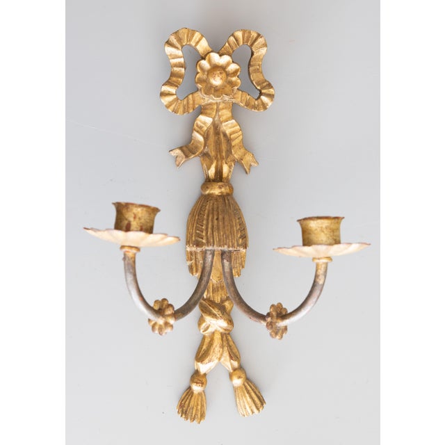 A lovely pair of Mid-Century Italian gilded wood and tole two arm candle wall sconces, circa 1950. Marked "Made in Italy"...
