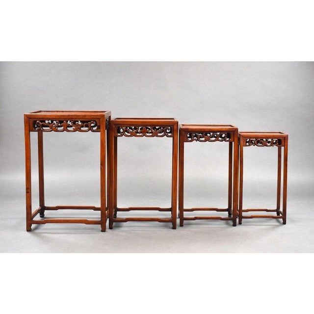 Set Four graduated Chinese hardwood nest tables in good condition with intricate carvings to the front and sides circa 1890