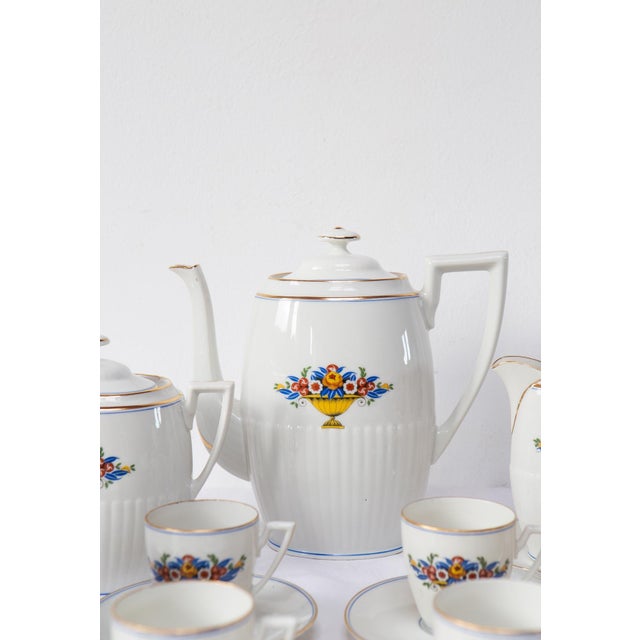 The set is composed by the following 26 pieces: 11 cups: ⌀ 6,5 cm, 6,5 cm high 11 saucers: ⌀ 13 cm 1 coffee pot:...