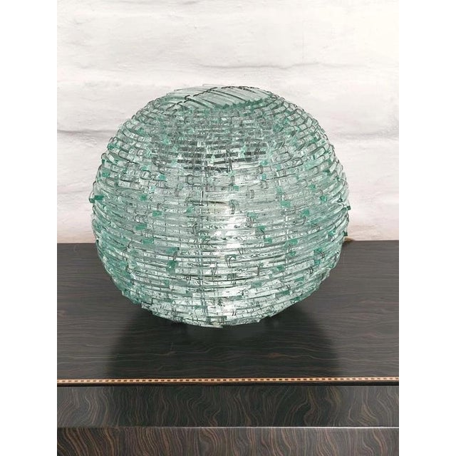 This remarkable "Tao" table lamp is a rare example of Italian glass design from the 1960s . The spherical shade is...