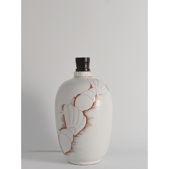 The Snäcka (seashell in Swedish) table lamp, designed by Anna-Lisa Thomson for Upsala-Ekeby in the 1940s, is a stunning...