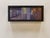 The painting captures a moment beneath a bridge, where light filters through the structural elements, creating a dynamic...