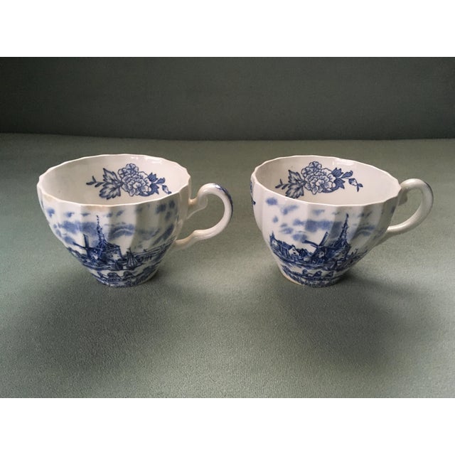 A pair of fluted blue and white china tea cups in the “Tulip Time” pattern. Ships within 1-2 days using USPS. All items...