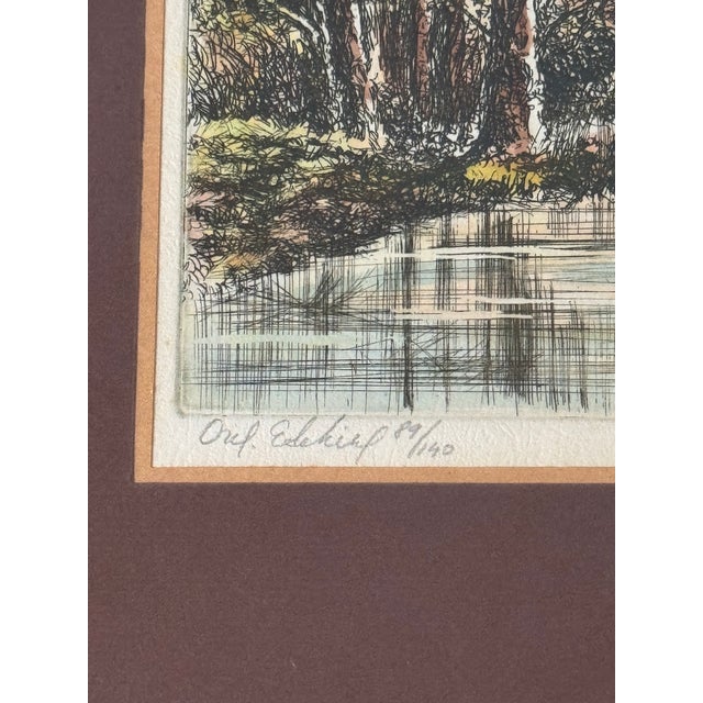 This beautiful signed and numbered etching by L. Mariae captures a serene wooded landscape reflected in a tranquil body of...
