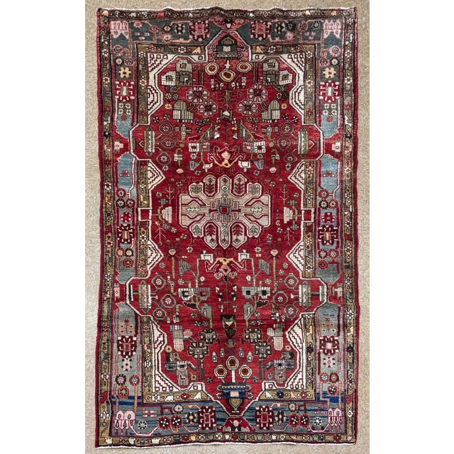Antique hand-knotted rug from the Nahavand region in western Iran, featuring a dense, highly detailed field centered...