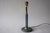 The 1980s gave the classic column lamp a wardrobe change. The form stayed traditional — a slender shaft on a round foot —...