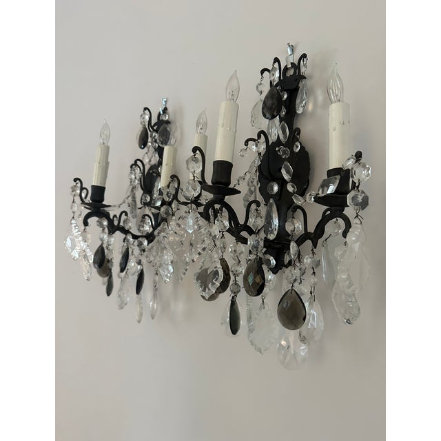 Pair of late 19th century French Rocco style Iron and crystal sconces with clear and amethyst colored crystals