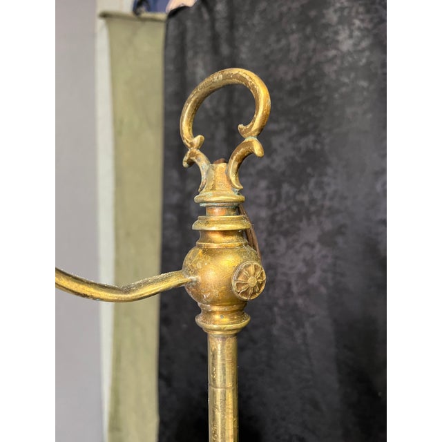 This brass bridge floor lamp reflects the popular lighting designs of the early 20th century, specifically the Art Deco...