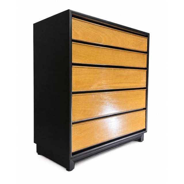 A striking vintage dresser by Kroehler, featuring a clean mid-century modern profile with a bold black outer case and warm...