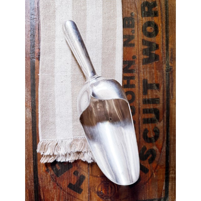 A lovely antique circa 1920s heavy silver plated ice scoop from a hotel. Made by Reed and Barton, there is an engraved...