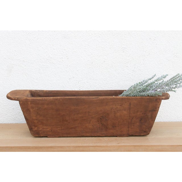 Carved from a single, massive log of hardwood, this antique wooden trough was likely originally used in a village setting...