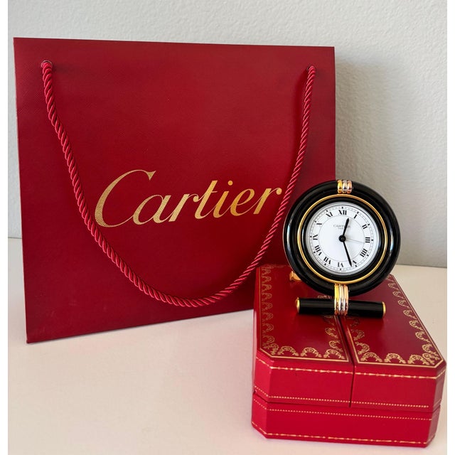 Cartier Vendome “Trinity” Travel Alarm Clock, Black Enamel & Tri-Color Gold, France, circa 1990s A refined and highly...