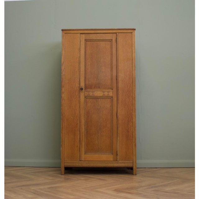A handsome 1930s oak hall robe produced as part of a collaboration between Harris Lebus and Bath Cabinet Makers, bearing...
