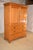Early 19th century pine linen press from England. The top of the case has a stately crown molding over simple sides and...