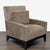 This West Elm lounge armchair features a modern design with clean lines and a soft brown upholstery. The cushioned seat...
