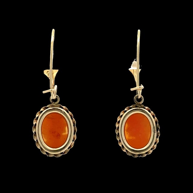 Elegant drop earrings crafted in 14k yellow gold, featuring intricate cameo portraits. Each cameo is set in an oval frame...