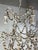 Hand crafted six light iron & wood beaded chandelier. This chandelier has a distressed vintage-inspired design with an...