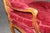 A striking and exceptionally decorative pair of French Louis XV style fauteuil armchairs, richly carved in solid beechwood...
