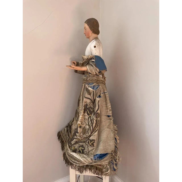 An elegant and exquisitely beautiful 19th century European wooden "cage doll" polychrome Santos, or Madonna figure with...