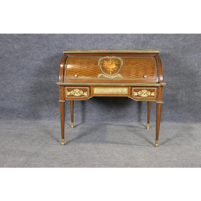 This exceptional French Louis XVI style cylinder roll-top desk is a masterful expression of nineteenth-century...