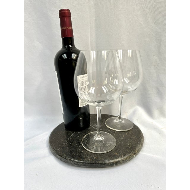 Rustic hand carved stone plate originally used over heat for cooking. Chosen for it's unique texture, form, and aged...