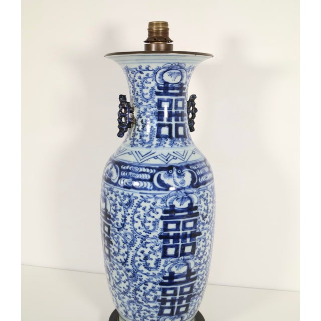 A large Chinese Qing Dynasty Double Happiness blue and white table lamp mounted over patinated brass base with top cover...