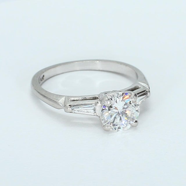 Stone Information - 1x - Round Diamond - VVS2/G - ~0.75ct 2x - Tapered Baguette Diamonds - VVS2/H - ~0.14ctw Ring Size -...