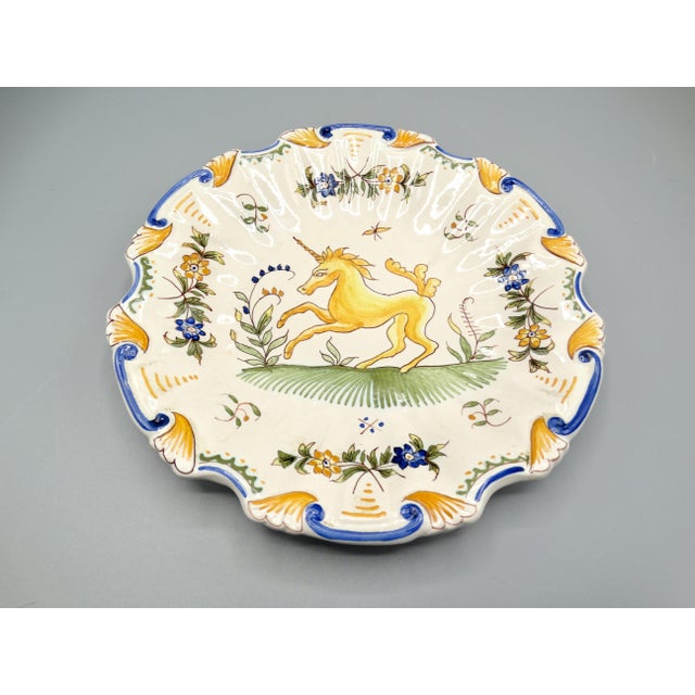 Early 20th-Century French Moustiers plate with unicorn. This lovely lobed faience plate is hand painted with a yellow and...