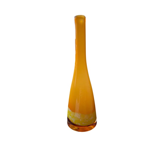 This glass vase showcases a beautiful amber to yellow gradient, which is characteristic of certain glassworks from the mid...