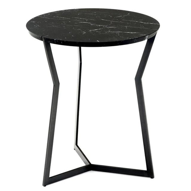 Nero marble star side table by Olivier Gagnère Materials: pedestal table, 20mm Carrara or Marquina marble top. Base in...