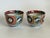 A pair of antique Japanese Imari porcelain tea bowls dating to the Meiji period (1868–1912). The decoration features...