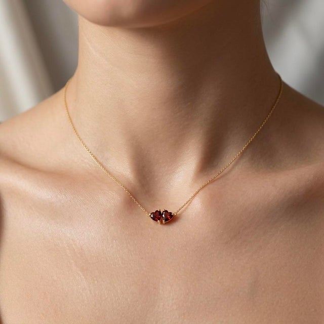 Infuse your jewelry collection with passionate warmth with this romantic two-stone pendant necklace, featuring two...