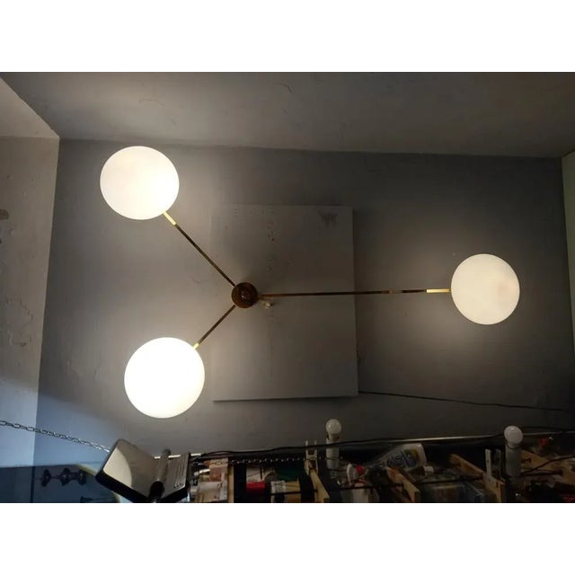 Wall Lamp Model Three Runes in Polished Brass in the style of Angel Lelii for Arredoluce, in Flawless conditions. Designed...