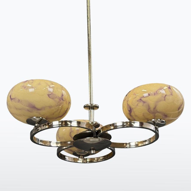 An elegant 1930s Art Deco chandelier featuring striking chrome arms and original yellow bowl-shaped glass shades. Its airy...