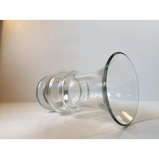 This clear glass vase with a hooped body was designed by Tamara Aladin and manufactured by Riihimäen Lasi in Finland...