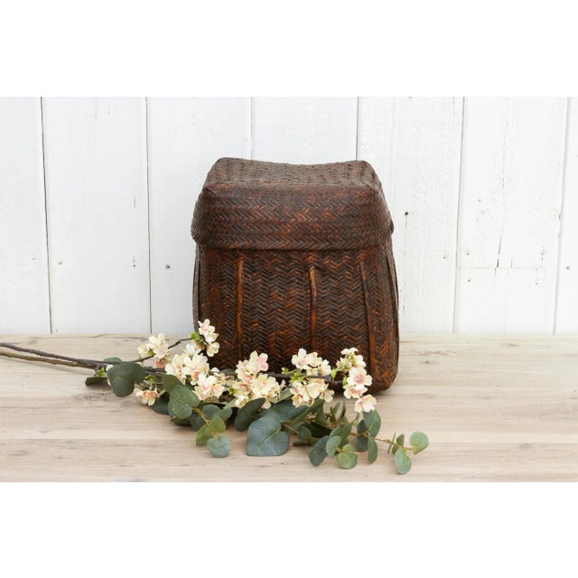 A beautiful antique Early 20th century woven square basket from Nepal originally used to store rice or grains. The antique...