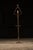 Ornate brass lamp with what appears to be the head of a crozier on top and an attached ashtray and non-functional, built-...