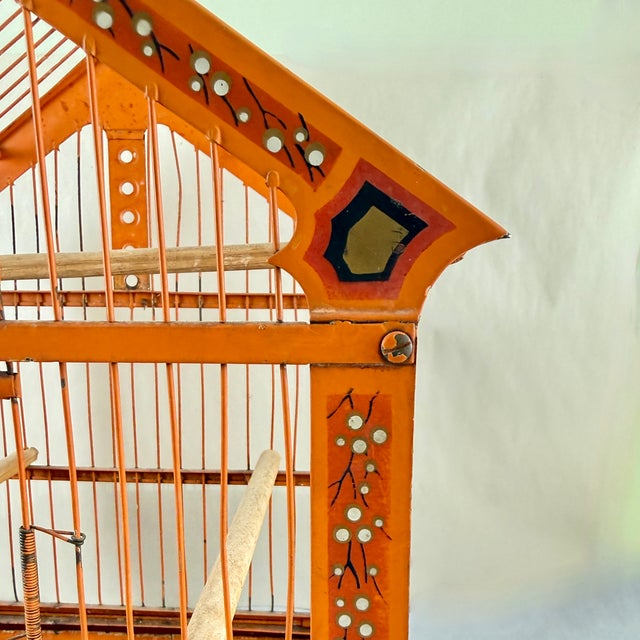 A scarce Art Deco era painted metal or Jappaned bird cage, possibly German, circa 1900-1920. The bright orange square cage...