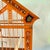 A scarce Art Deco era painted metal or Jappaned bird cage, possibly German, circa 1900-1920. The bright orange square cage...