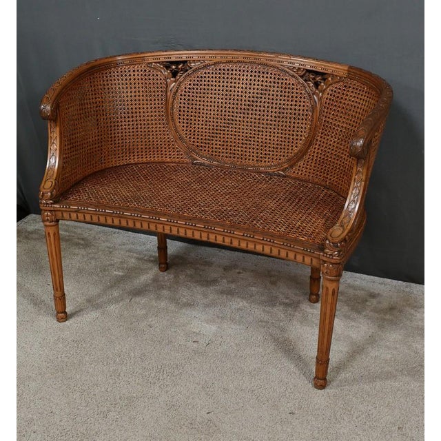 Charming Louis XVI style walnut basket bench dating from the 19th century. This furniture is richly carved with friezes of...